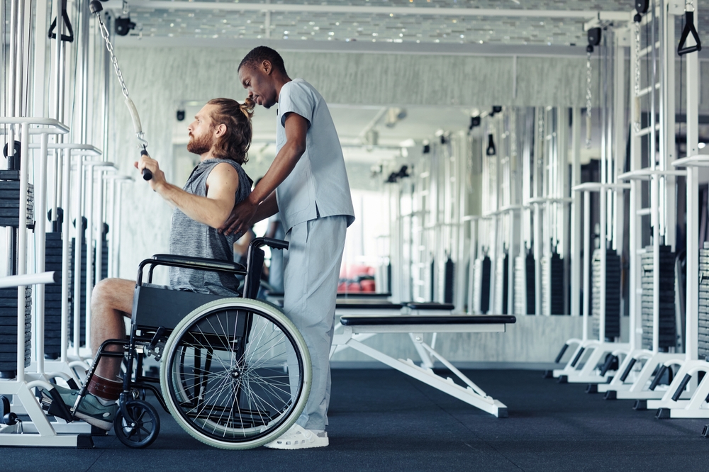 a person in a wheelchair doing a cable workout at disability gym in Alice Springs.